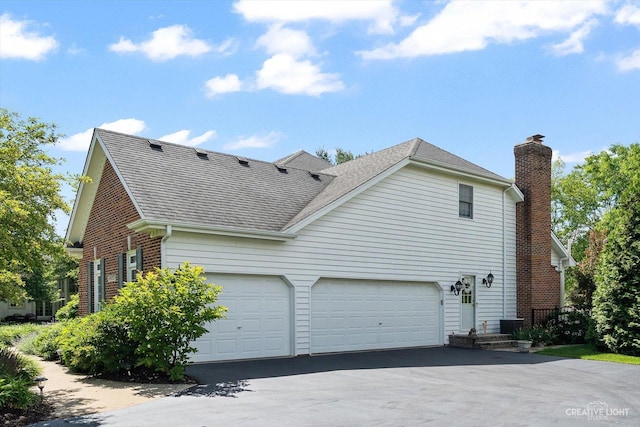 39W835 Carl Sandburg Rd, Saint Charles, IL 60175 - view of home's exterior featuring roof with shingles, a chimney, driveway, and brick siding