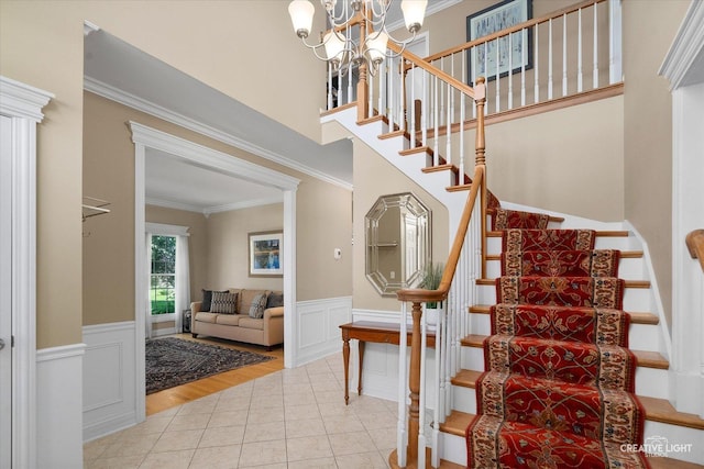 39W835 Carl Sandburg Rd, Saint Charles, IL 60175 - staircase with ornamental molding, tile patterned flooring, a chandelier, a wainscoted wall, and a decorative wall