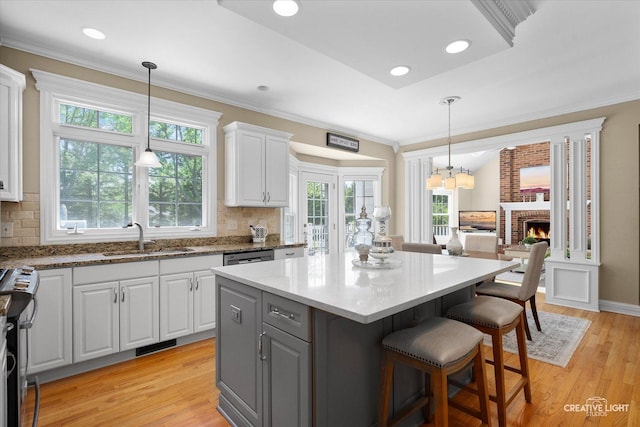 39W835 Carl Sandburg Rd, Saint Charles, IL 60175 - kitchen with a sink, white cabinetry, gray cabinetry, light wood finished floors, and a kitchen island