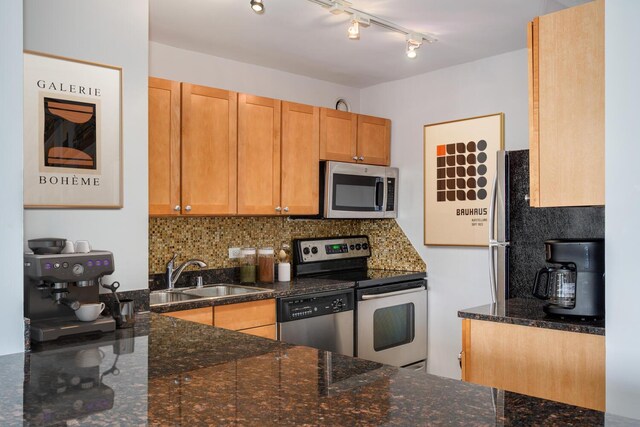 30 E Huron St Unit 4108, Chicago, IL 60611 - kitchen with appliances with stainless steel finishes, a sink, backsplash, dark stone counters, and track lighting