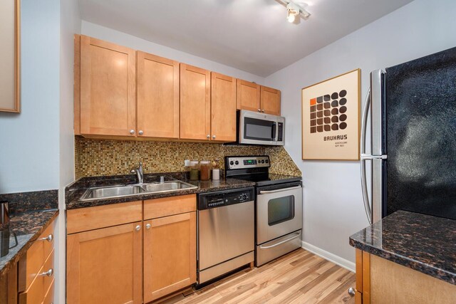 30 E Huron St Unit 4108, Chicago, IL 60611 - kitchen with appliances with stainless steel finishes, a sink, light wood-type flooring, backsplash, and baseboards