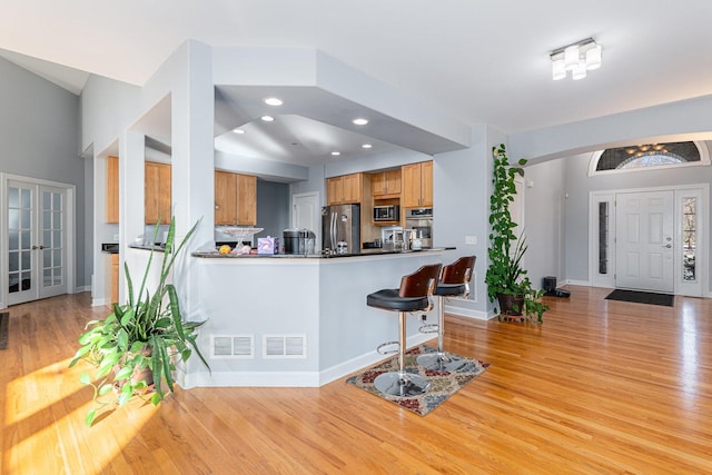 876 Hampstead Ct, Barrington, IL 60010 - kitchen featuring stainless steel appliances, light wood-style floors, a peninsula, baseboards, and a breakfast bar