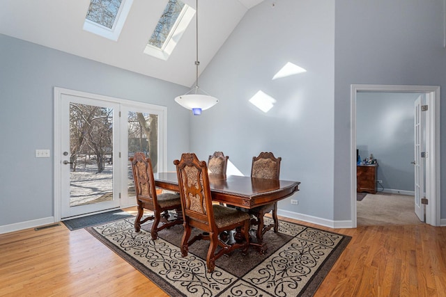 876 Hampstead Ct, Barrington, IL 60010 - dining area with light wood-style flooring, high vaulted ceiling, a skylight, and baseboards