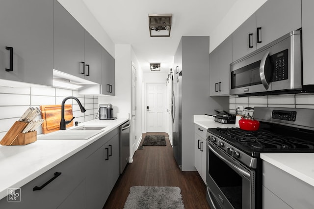 9352 Sunrise Ln Unit B1, Orland Park, IL 60462 - kitchen featuring stainless steel appliances, tasteful backsplash, light countertops, and dark wood-type flooring