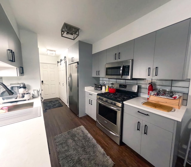 9352 Sunrise Ln Unit B1, Orland Park, IL 60462 - kitchen featuring appliances with stainless steel finishes, gray cabinets, dark wood-style flooring, and light countertops