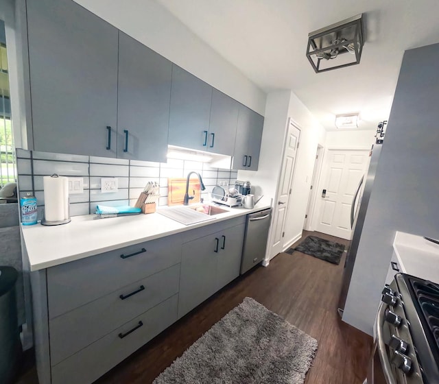 9352 Sunrise Ln Unit B1, Orland Park, IL 60462 - kitchen featuring a sink, stainless steel appliances, decorative backsplash, dark wood-style floors, and gray cabinetry
