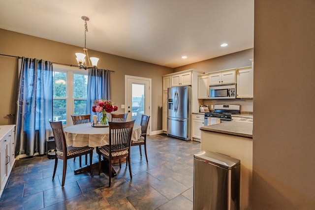 2786 Shepard Rd, Normal, IL 61761 - dining area with a chandelier, recessed lighting, dark stone finish flooring, and baseboards