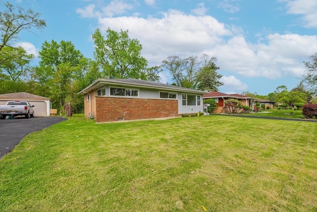16228 Sussex Ave, Markham, IL 60428 - view of front facade with brick siding, a garage, a front yard, and an outdoor structure