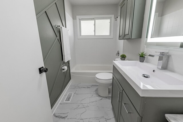 16228 Sussex Ave, Markham, IL 60428 - bathroom featuring marble look tiles, toilet, vanity, and washtub / shower combination