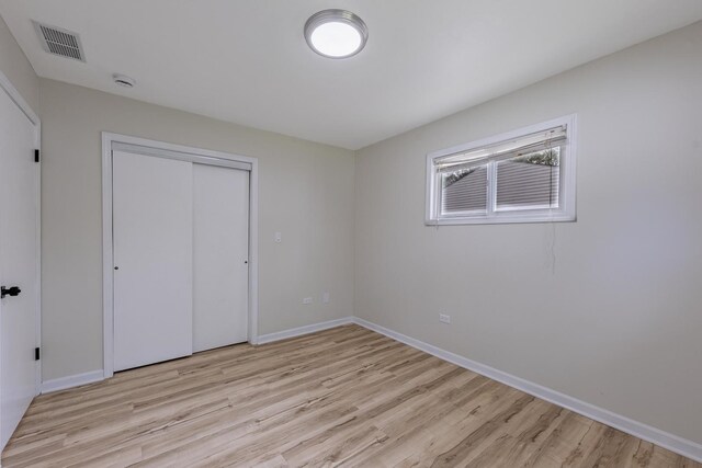 16228 Sussex Ave, Markham, IL 60428 - unfurnished bedroom with light wood-style floors, baseboards, and a closet