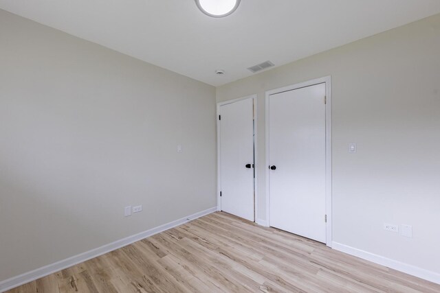 16228 Sussex Ave, Markham, IL 60428 - unfurnished bedroom with light wood-style flooring, baseboards, and a closet