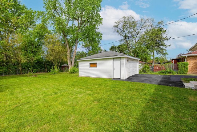16228 Sussex Ave, Markham, IL 60428 - view of grassy yard with an outdoor structure and a detached garage