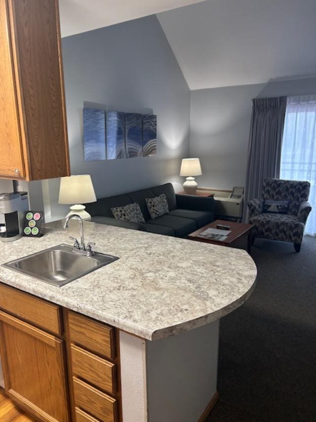 111 Center St Unit 441, Lake Geneva, WI 53147 - kitchen with a sink, open floor plan, light countertops, vaulted ceiling, and a peninsula