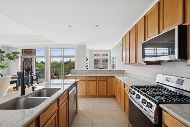 100 Prairie Park Dr Unit 210, Wheeling, IL 60090 - kitchen with appliances with stainless steel finishes, a sink, light tile patterned floors, light stone counters, and ornamental molding