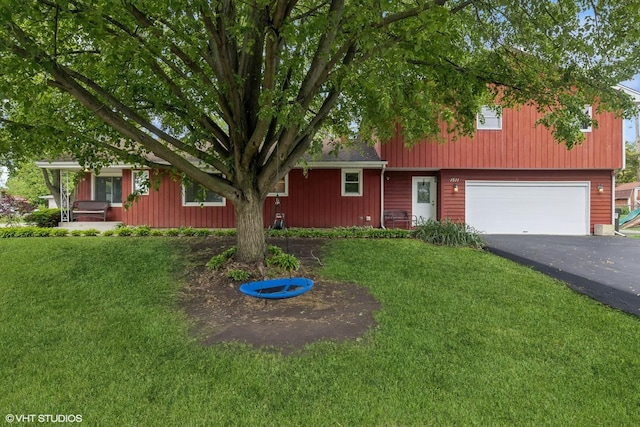 1511 Lakeland Ave, Mchenry, IL 60050 - view of front of home with asphalt driveway, a front lawn, and an attached garage
