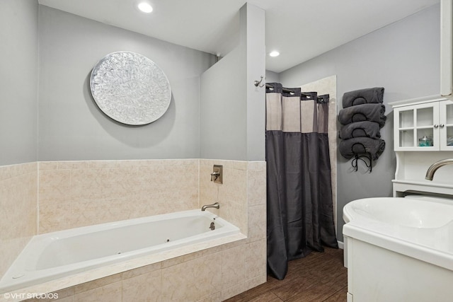 1511 Lakeland Ave, Mchenry, IL 60050 - bathroom featuring a tub with jets, vanity, wood finished floors, tiled shower, and recessed lighting