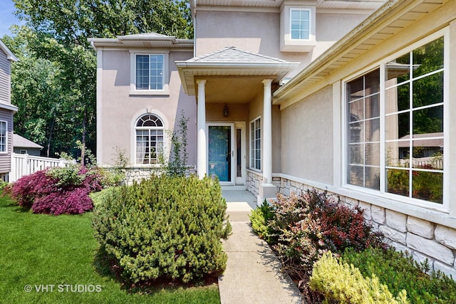 1031 S Wellington Rd, Waukegan, IL 60085 - doorway to property with stucco siding, stone siding, and a yard