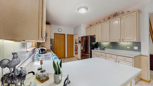 1031 S Wellington Rd, Waukegan, IL 60085 - kitchen with stainless steel fridge with ice dispenser, a sink, decorative backsplash, light countertops, and a peninsula