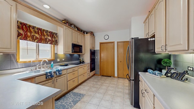 1031 S Wellington Rd, Waukegan, IL 60085 - kitchen featuring a sink, black appliances, backsplash, light countertops, and light tile patterned floors