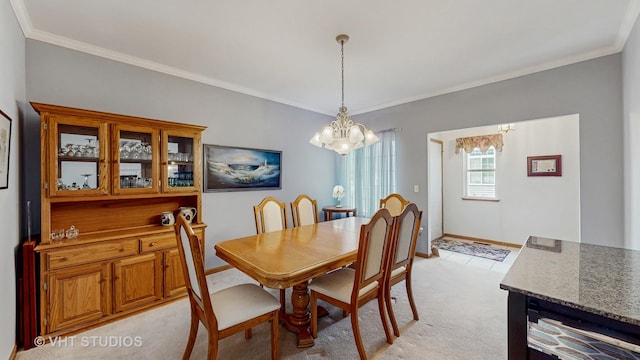 1031 S Wellington Rd, Waukegan, IL 60085 - dining area featuring a chandelier, light carpet, crown molding, and baseboards