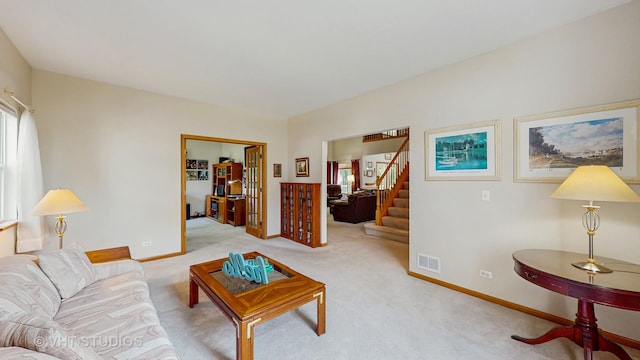 1031 S Wellington Rd, Waukegan, IL 60085 - living area featuring stairway, carpet floors, and baseboards