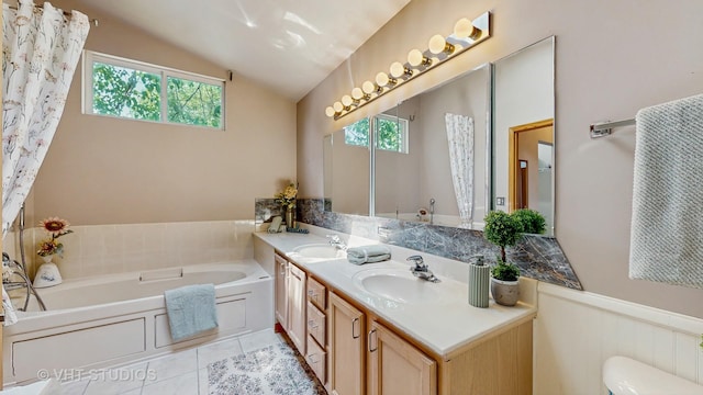 1031 S Wellington Rd, Waukegan, IL 60085 - full bath featuring lofted ceiling, double vanity, a bath, tile patterned floors, and a wainscoted wall