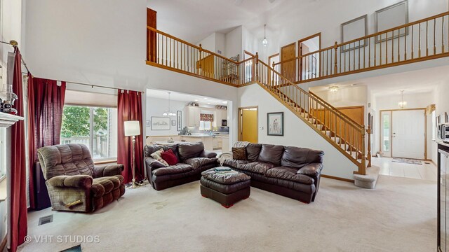 1031 S Wellington Rd, Waukegan, IL 60085 - living area with a high ceiling, carpet flooring, and stairs