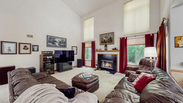 1031 S Wellington Rd, Waukegan, IL 60085 - carpeted living room featuring high vaulted ceiling and a tile fireplace