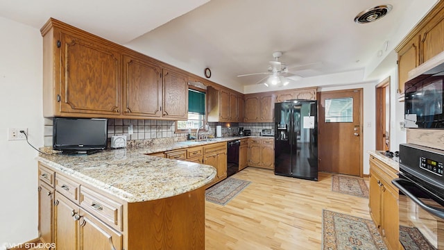 7421 N Crossway Rd, Fox Point, WI 53217 - kitchen with black appliances, a peninsula, decorative backsplash, ceiling fan, and light wood-type flooring