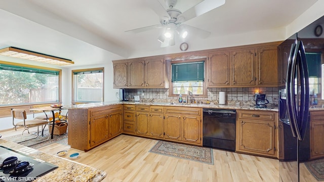 7421 N Crossway Rd, Fox Point, WI 53217 - kitchen featuring black appliances, light wood-style floors, backsplash, and a sink