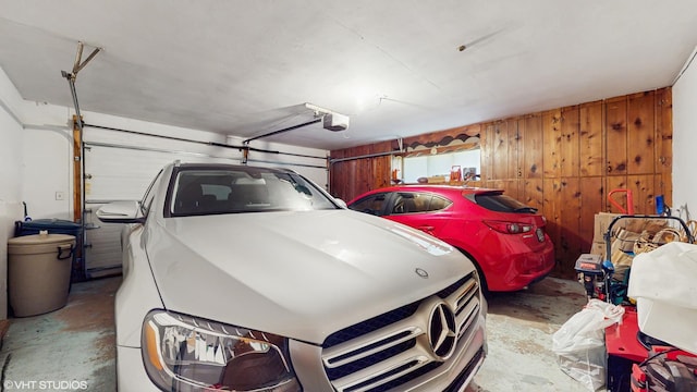 7421 N Crossway Rd, Fox Point, WI 53217 - garage featuring a garage door opener and wood walls