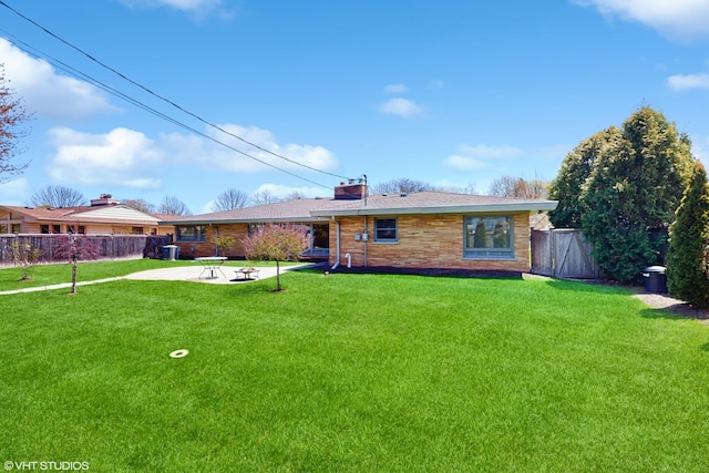 7421 N Crossway Rd, Fox Point, WI 53217 - back of house with an outdoor fire pit, a chimney, and a patio area