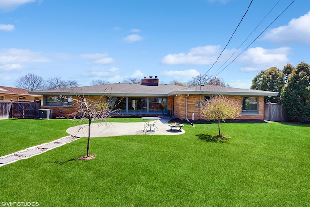 7421 N Crossway Rd, Fox Point, WI 53217 - ranch-style home featuring a patio, a chimney, central AC unit, brick siding, and roof with shingles