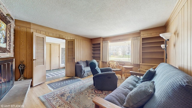 7421 N Crossway Rd, Fox Point, WI 53217 - living area with wooden walls, hardwood / wood-style flooring, and a textured ceiling