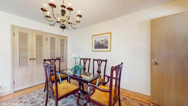 7421 N Crossway Rd, Fox Point, WI 53217 - dining area with a chandelier, light wood-type flooring, and baseboards