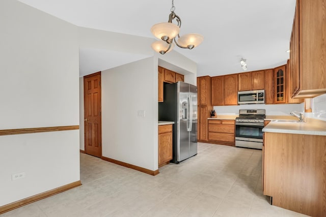 1328 Sunrise Ln, Gurnee, IL 60031 - kitchen with appliances with stainless steel finishes, a sink, light countertops, brown cabinets, and a chandelier