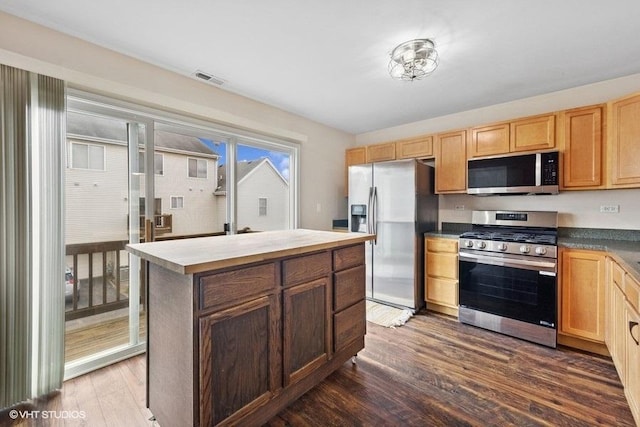 897 Clover Ln, Pingree Grove, IL 60140 - kitchen featuring stainless steel appliances, dark wood-type flooring, a kitchen island, and light brown cabinetry