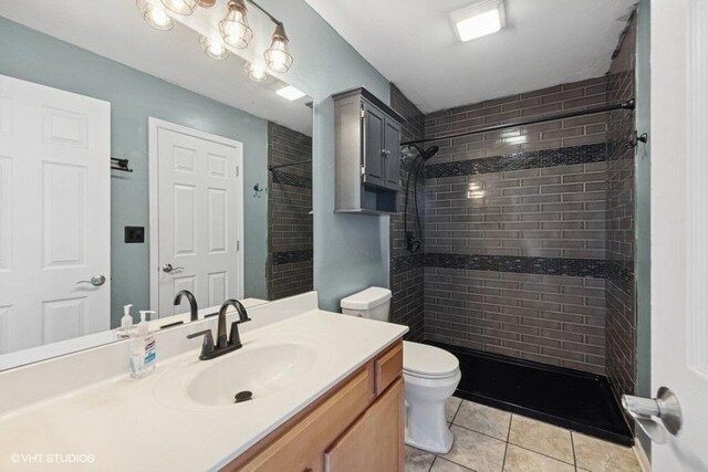 897 Clover Ln, Pingree Grove, IL 60140 - full bathroom featuring tile patterned flooring, a tile shower, toilet, and vanity