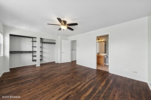 897 Clover Ln, Pingree Grove, IL 60140 - unfurnished bedroom featuring wood finished floors, baseboards, a ceiling fan, connected bathroom, and multiple closets