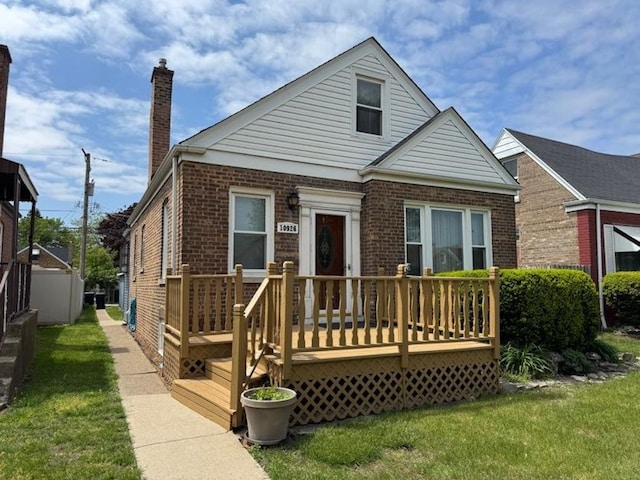10926 S S Ave Unit B, Chicago, IL 60617 - bungalow featuring brick siding, a front yard, and a deck