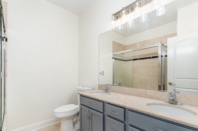 641 E 50th St Unit 3, Chicago, IL 60615 - bathroom with double vanity, a shower stall, toilet, and tile patterned floors