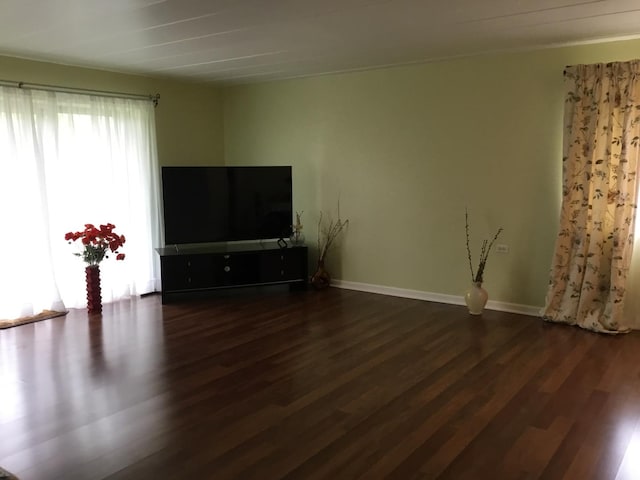200 Deborah Ln NW Unit 16A, Wheeling, IL 60090 - unfurnished living room with dark wood-type flooring and baseboards