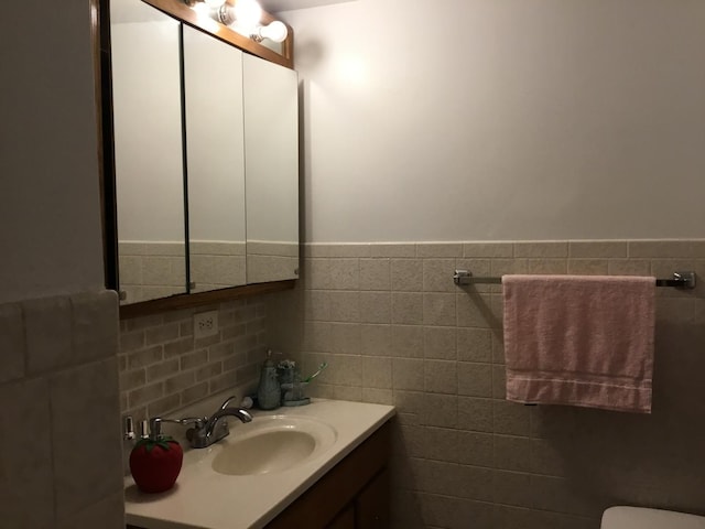 200 Deborah Ln NW Unit 16A, Wheeling, IL 60090 - half bath with vanity, tile walls, a wainscoted wall, and toilet