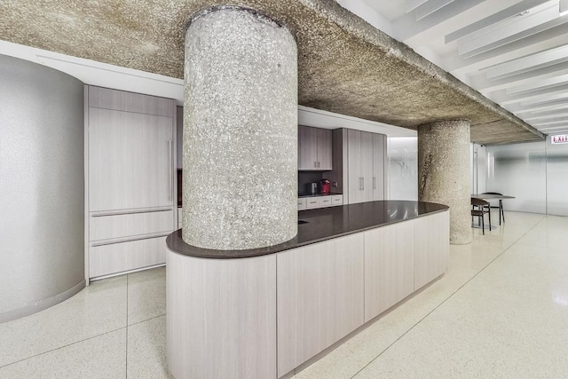 200 E Delaware Pl Unit 18F, Chicago, IL 60611 - kitchen featuring dark aggregate flooring, dark countertops, and baseboards