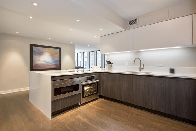 200 E Delaware Pl Unit 18F, Chicago, IL 60611 - kitchen with wall oven, a sink, modern cabinets, light wood finished floors, and recessed lighting