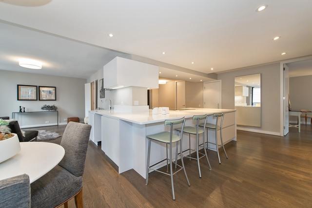 200 E Delaware Pl Unit 18F, Chicago, IL 60611 - kitchen featuring dark wood finished floors, white cabinets, a kitchen breakfast bar, and recessed lighting