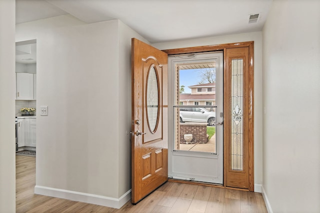 1083 Groton Ct, Schaumburg, IL 60193 - foyer entrance featuring light wood finished floors and baseboards