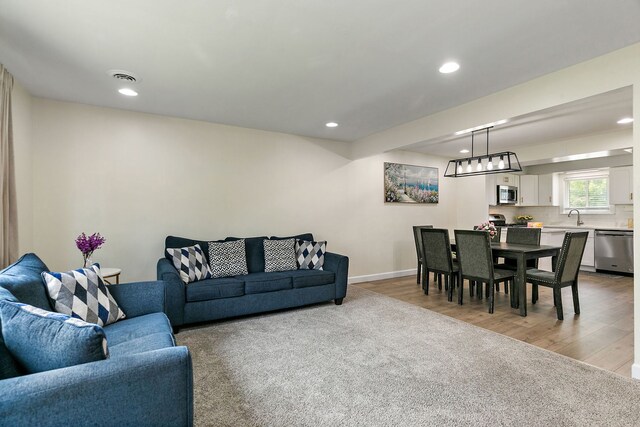 1083 Groton Ct, Schaumburg, IL 60193 - living area with light wood finished floors, recessed lighting, and baseboards