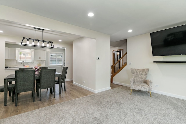 1083 Groton Ct, Schaumburg, IL 60193 - dining area with recessed lighting, light colored carpet, stairs, baseboards, and light wood-type flooring