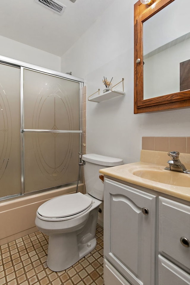 1083 Groton Ct, Schaumburg, IL 60193 - bathroom with vanity, toilet, bath / shower combo with glass door, and tile patterned floors